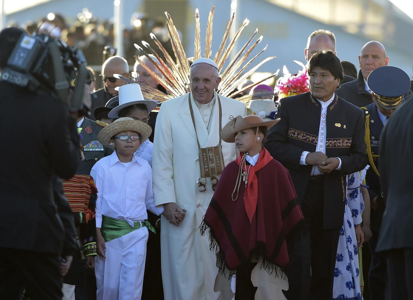 Pope Francis greets indigenous children next to Bolivian President Evo Morales during a welcoming ceremony in El Alto, a plateau over La Paz, 4,000 meters above sea level, on his first visit to Bolivia.