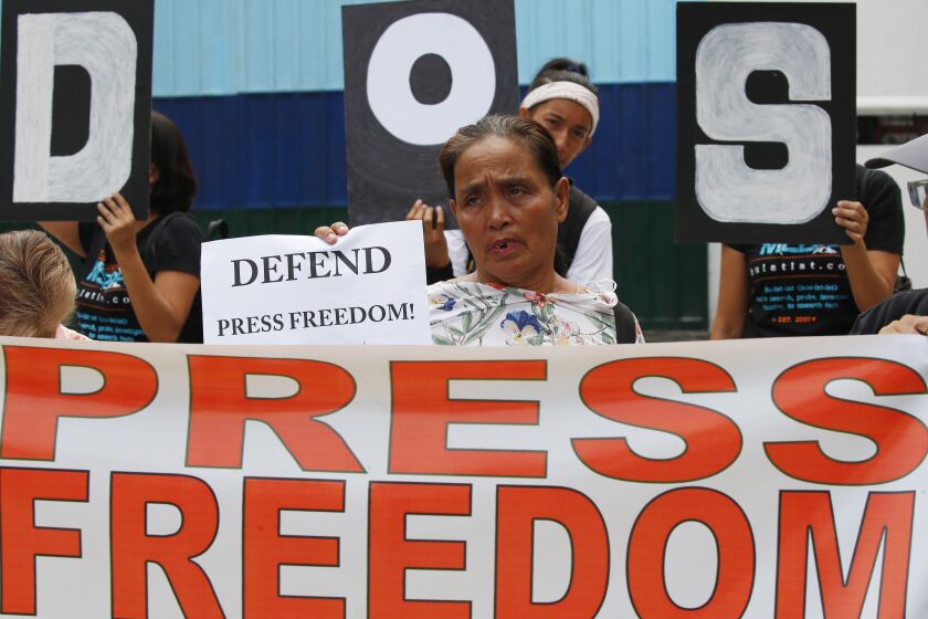 FILE - In this May 3, 2019, file photo, protesters rally outside the armed forces headquarters to mark World Press Freedom Day which was declared by the UN General Assembly in Manila, Philippines. The Philippine government’s chief lawyer is asking the Supreme Court to shut down the country’s largest TV network by revoking its operating franchises because of alleged constitutional violations, in a move critics call an attempt to muzzle the media. (AP Photo/Bullit Marquez, File )