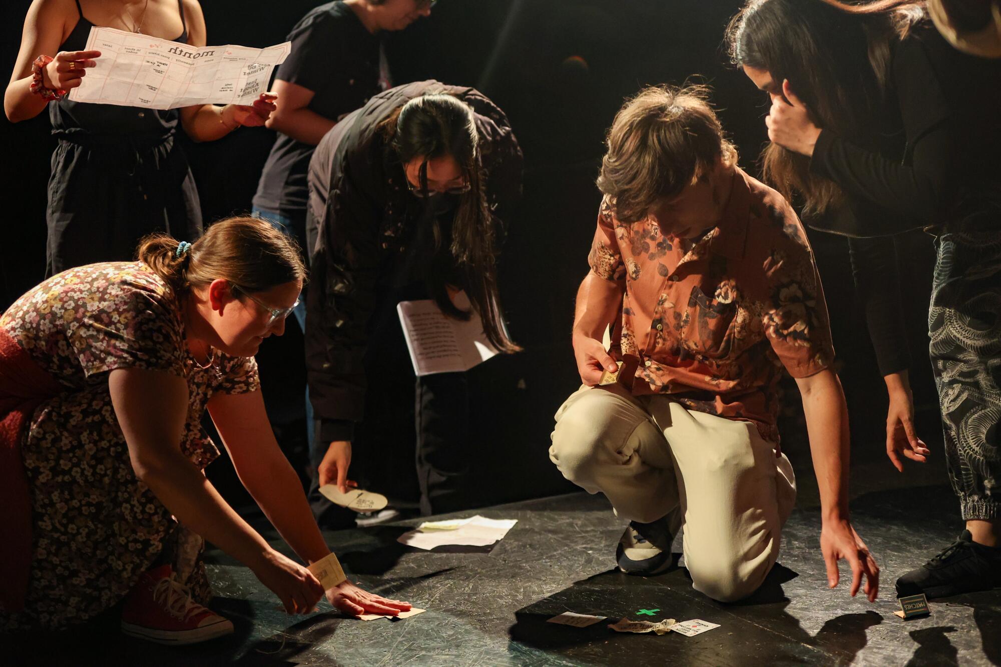 Audience members look at the floor for context clues to solve the next puzzle.