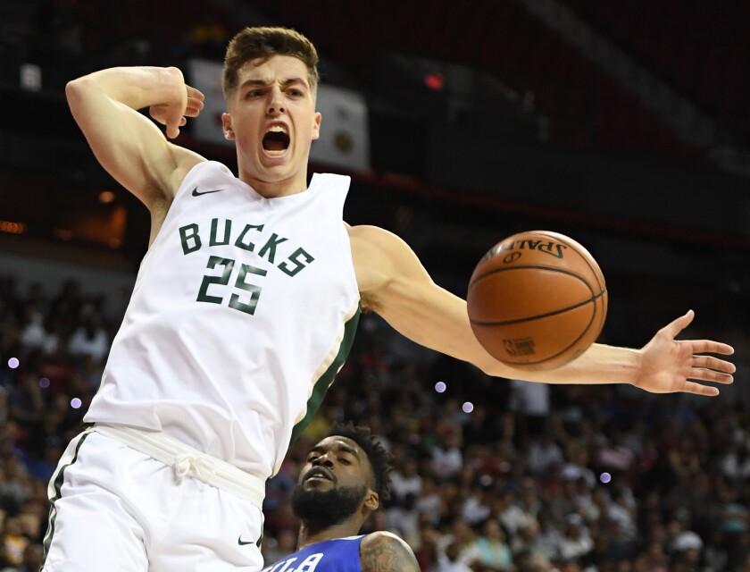 Daulton Hommes of the Milwaukee Bucks reacts after dunking in front of Norvel Pelle of the Philadelphia 76ers during the 2019 NBA Summer League at the Thomas & Mack Center in Las Vegas.