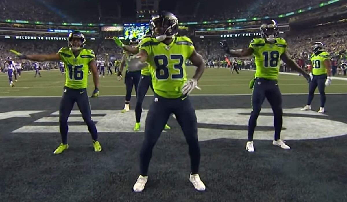 Seattle Seahawks receivers Tyler Lockett (16), David Morre (83) and Jaron Brown (18) celebrate a touchdown with New Edition dance moves.