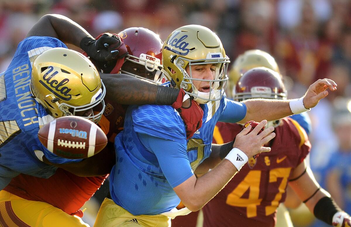 USC defensive lineman Claude Pelon forces UCLA quarterback Josh Rosen to fumble during the second half, leading to Rasheem Green's 31-yard return for a touchdown.