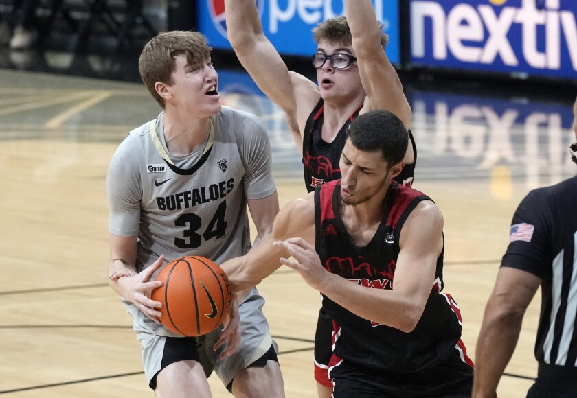 Eastern Washington guard Rylan Bergersen, front right, steals the ball as forward Casey Jones, back right, blocks Colorado center Lawson Lovering as he tries to drive the lane in the second half of an NCAA college basketball game Wednesday, Dec. 8, 2021, in Boulder, Colo. (AP Photo/David Zalubowski)
