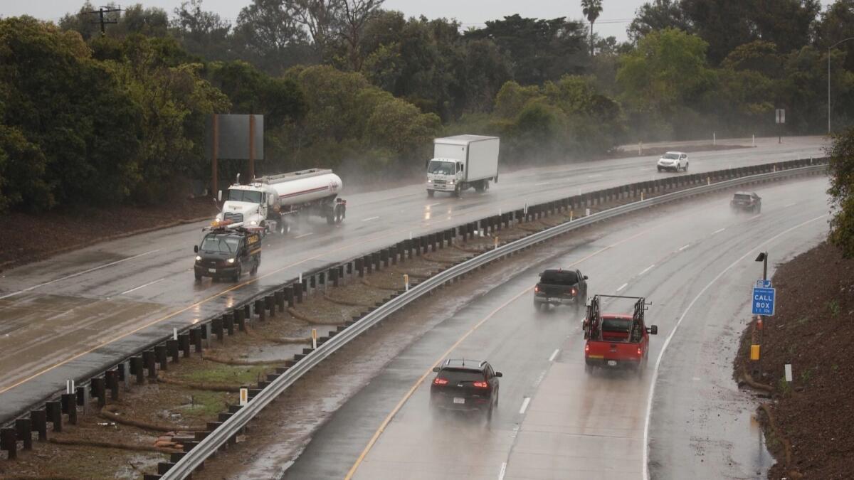 A small storm is bringing showers to Southern California on Tuesday and Wednesday, including the Thomas fire burn areas in Santa Barbara County. Above, rain soaks U.S. 101 in Montecito in March.