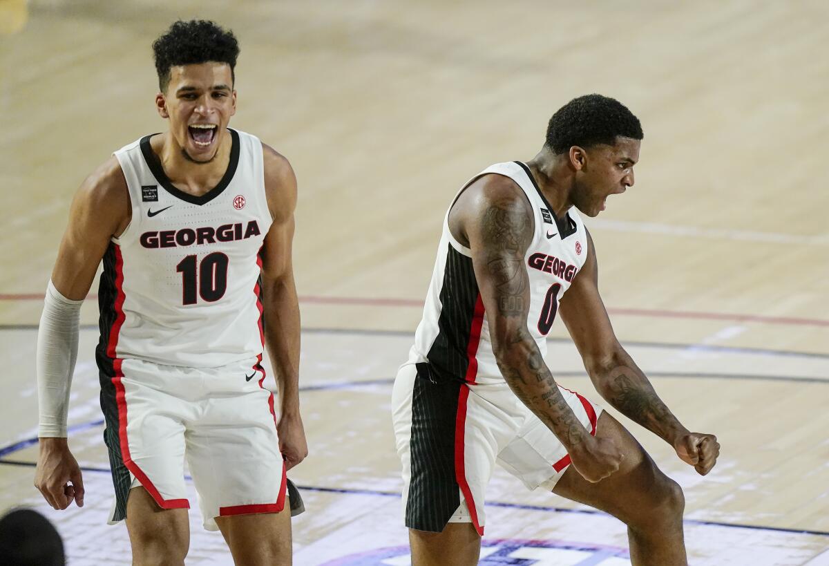 Georgia guard K.D. Johnson and forward Toumani Camara celebrate after Johnson scores.