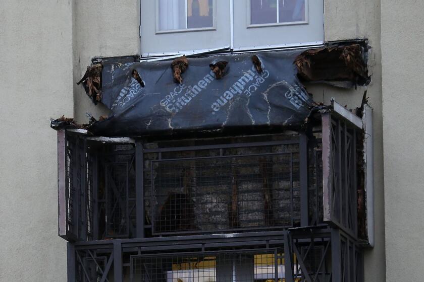 A section of collapsed balcony remains on the front of an apartment building in Berkeley.