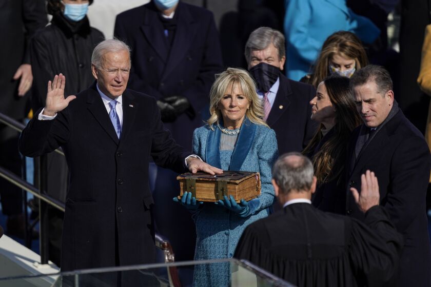 Washington , DC - January 20: U.S. President-elect Joe Biden takes the oath of office from Supreme Court Chief Justice John Roberts as his wife U.S. First Lady-elect Jill Biden stands next to him during the 59th presidential inauguration in Washington, D.C. on Wednesday, Jan. 20, 2021. . (Kent Nishimura / Los Angeles Times)