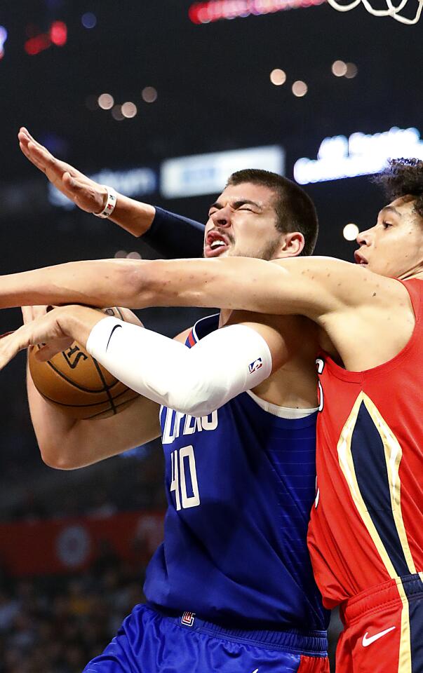 Clippers center Ivica Zubac is fouled by New Orleans Pelicans center Jaxson Hayes.