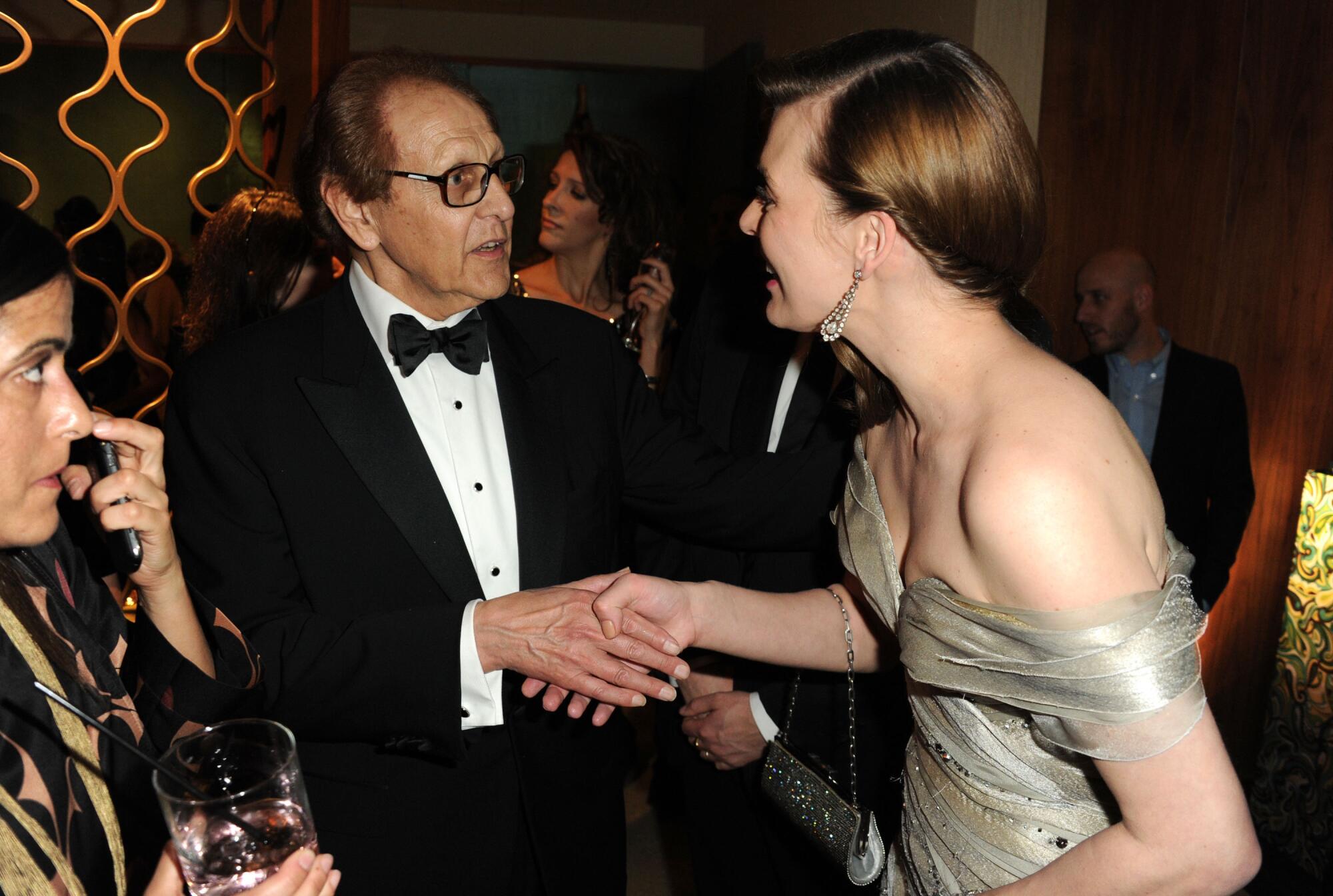 Attendees greet one another over drinks at a Golden Globes afterparty