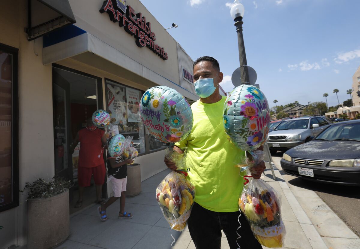 Nolan Kennedy, 56, from Chula Vista picked up two fruit gifts from Edible Arrangements in La Mesa for Mother's Day for his wife and daughter-in-law.