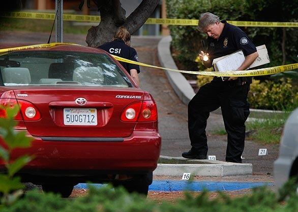 Crime scene investigators from the Irvine Police Department search for clues at the scene of a fatal shooting in the Verano Place student housing complex at UC Irvine. Brian Benedict, 35, a physics graduate student under suspicion of fatally shooting the mother of their child, Rebecca Benedict, 30, is in custody after the shooting Sunday night. It is the first homicide on the campus.