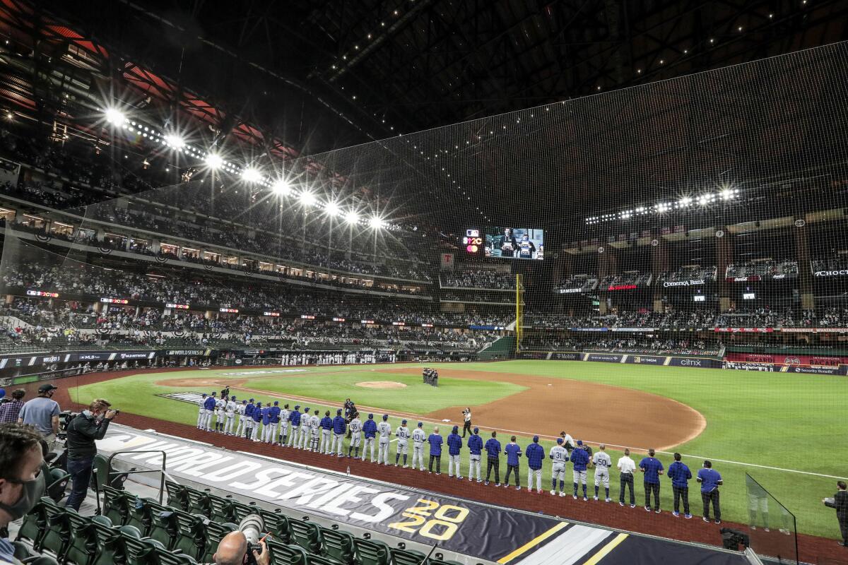 The Dodgers and the Tampa Bay Rays line up on the sides of the field before Game 3 of the World Series.