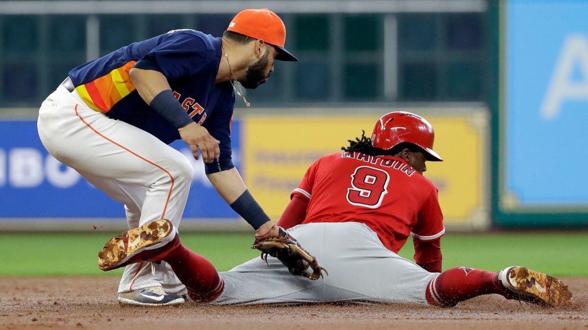 The Angels' Cameron Maybin steals second base safely as Houston Astros shortstop Marwin Gonzalez applies the tag during the third inning on June 11.