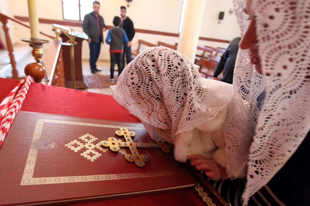 An Assyrian Christian woman and her daughter, who had fled the unrest in Syria, attend a prayer at the St.Georges Assyrian Church in Jdeideh, northeast of Beirut, for the Assyrian Christians abducted by Islamic State militants from villages in northeastern Syria.