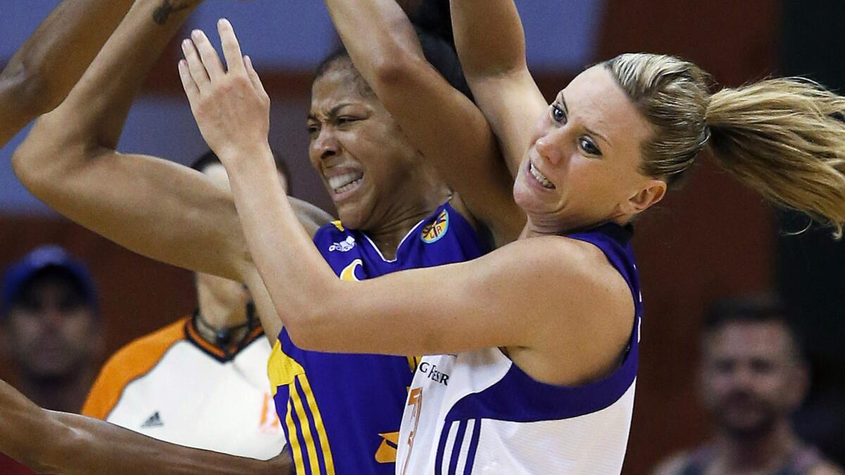 Sparks forward Candace Parker, left, and Phoenix's Penny Taylor battle for the ball during Game 1 of the WNBA Western Conference semifinals on Friday.