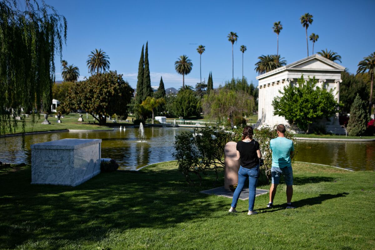 People visit the grave of actress, singer-songwriter and comedian Hattie McDaniel's at the Hollywood Forever Cemetery.