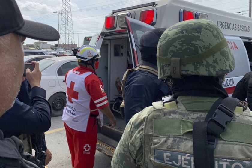 A Red Cross worker closes the door of an ambulance carrying two Americans found alive after their abduction in Mexico last week, in Matamoros, Tuesday, March 7, 2023. Two of four Americans whose abduction in Mexico was captured in a video that showed them caught in a cartel shootout have been found dead, officials said Tuesday. The two surviving Americans were taken to the border near Brownsville, Texas, in a convoy of Mexican ambulances and SUVs. (AP Photo)