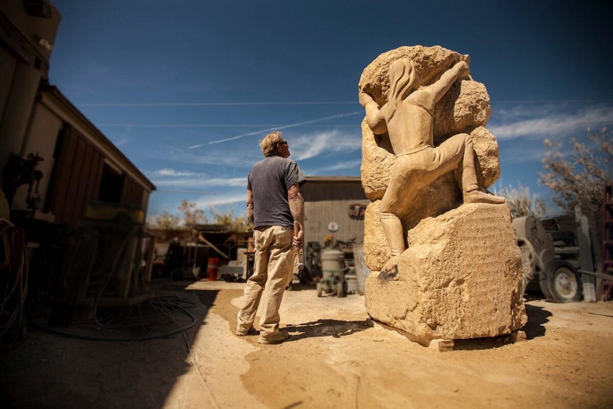 David Falossi, a San Diego sculptor, with his piece titled "The Spirit Climb."