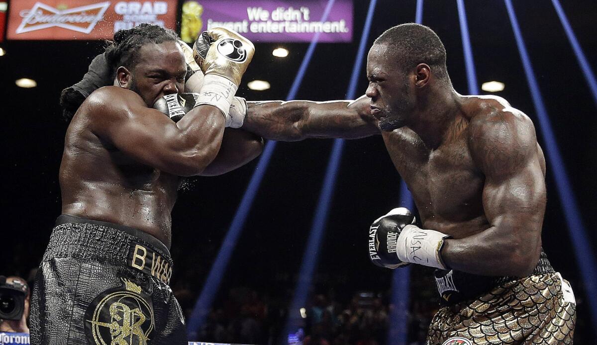 Deontay Wilder lands a punch against Bermane Stiverne during their WBC heavyweight championship bout on Saturday night at the MGM Grand Garden Arena in Las Vegas.