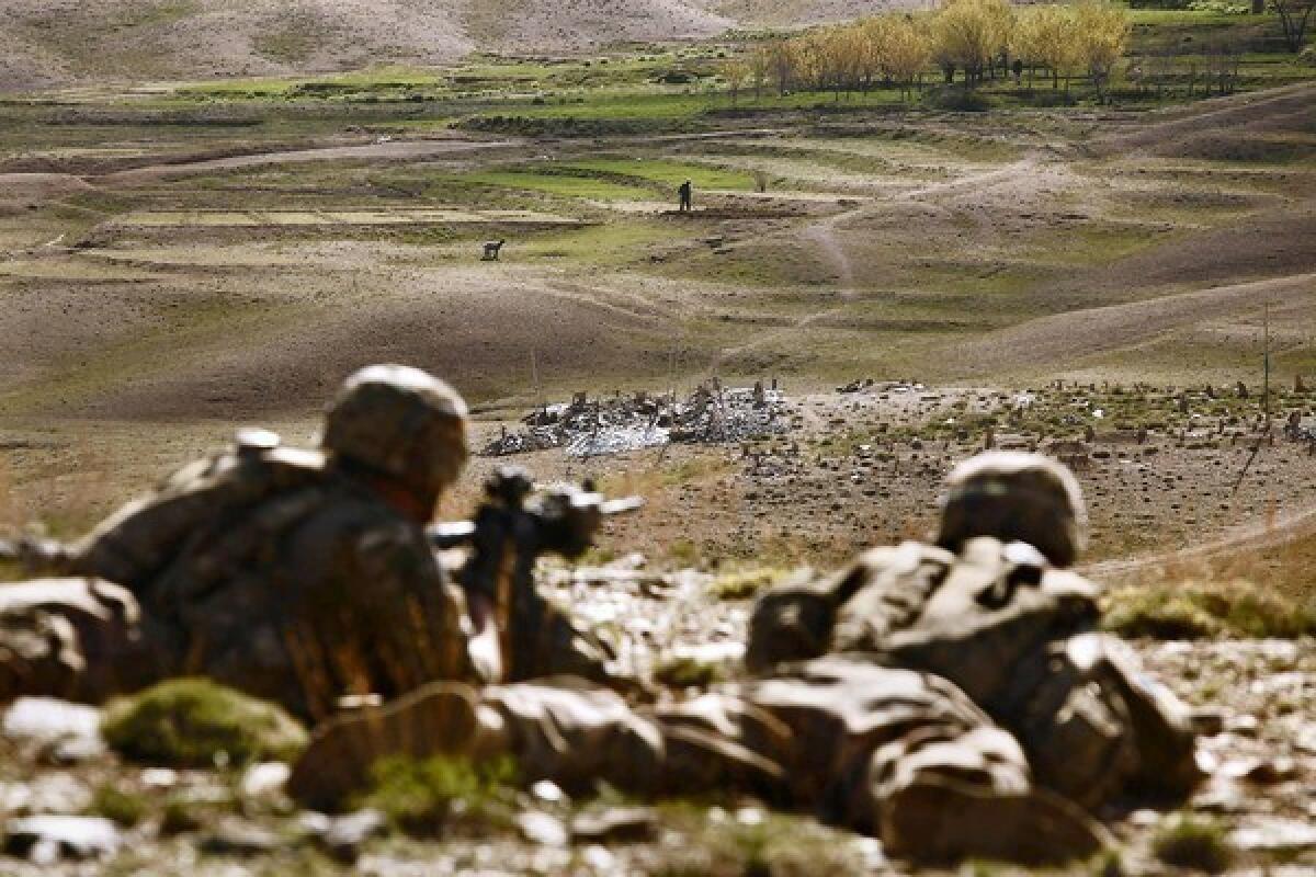U.S. soldiers take part in an overwatch operation in Afghanistan's Wardak province by keeping an eye on Afghan forces on patrol and preparing them to take over security.