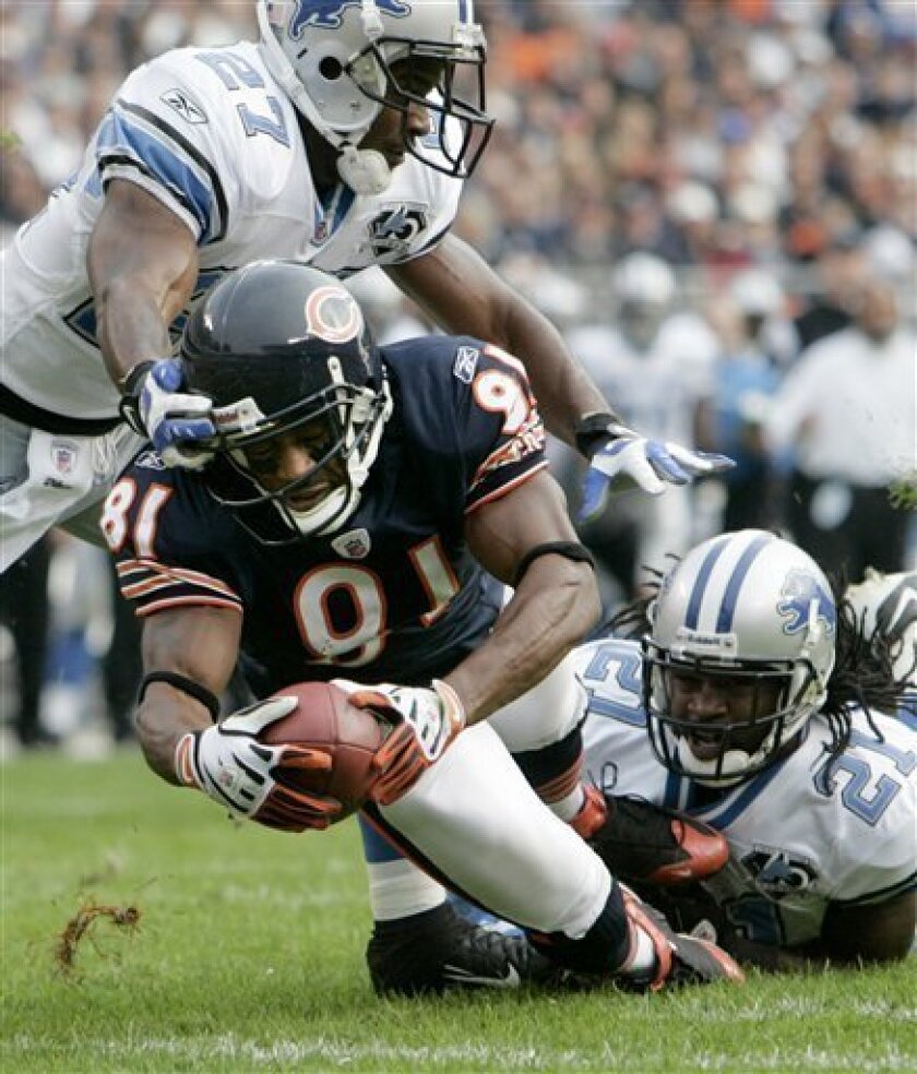 Chicago Bears wide receiver Rashied Davis dives into the end zone past Detroit Lions defenders Daniel Bullocks, left, and Travis Fisher after catching a pass from quarterback Rex Grossman during the third quarter of an NFL football game in Chicago, Sunday, Nov. 2, 2008. (AP Photo/Nam Y. Huh)
