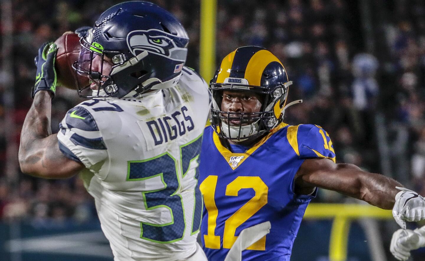 Seattle Seahawks cornerback Quandre Diggs intercepts a pass intended for Rams wide receiver Brandin Cooks.