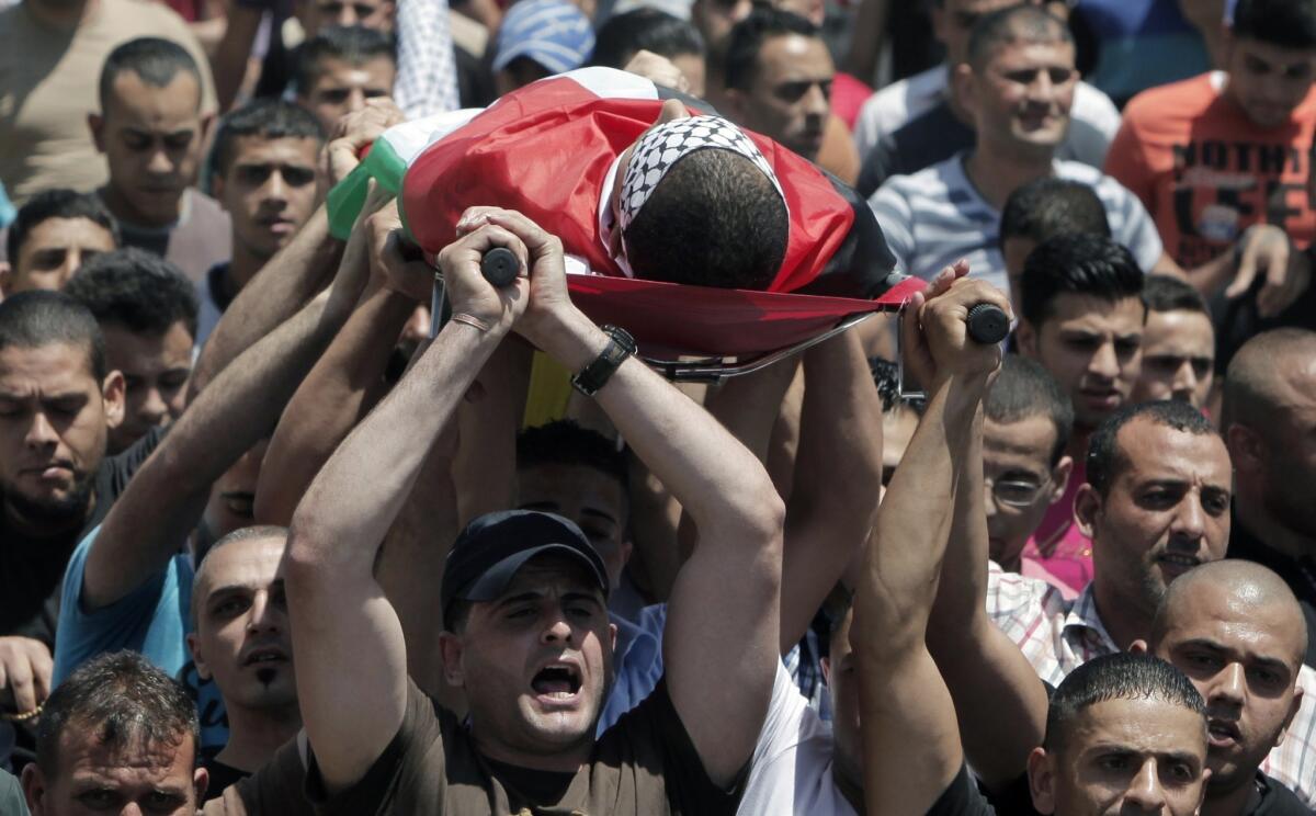 Palestinian mourners carry the body of Ahmad Fahmawi, 27, in the West Bank city of Nablus on Sunday, after he was killed by Israeli troops.