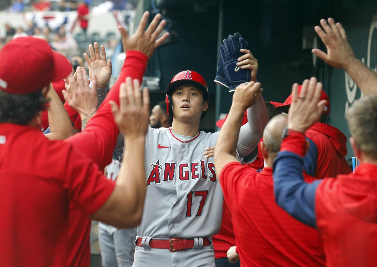 Angels designated hitter Shohei Ohtani celebrates after scoring a run in the third inning against the Texas Rangers.
