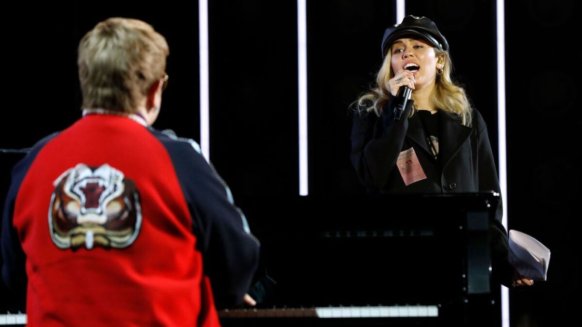 Elton John rehearses with Miley Cyrus for the Grammy Awards.