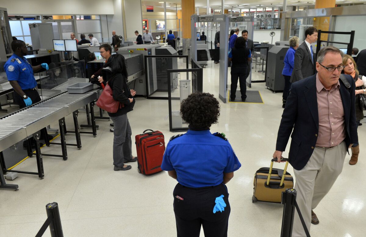 TSA agents work at a checkpoint for pre-cleared passengers at Hartsfield-Jackson Atlanta International Airport. The Department of Homeland Security is pushing private contractors for new technology to screen airline passengers.