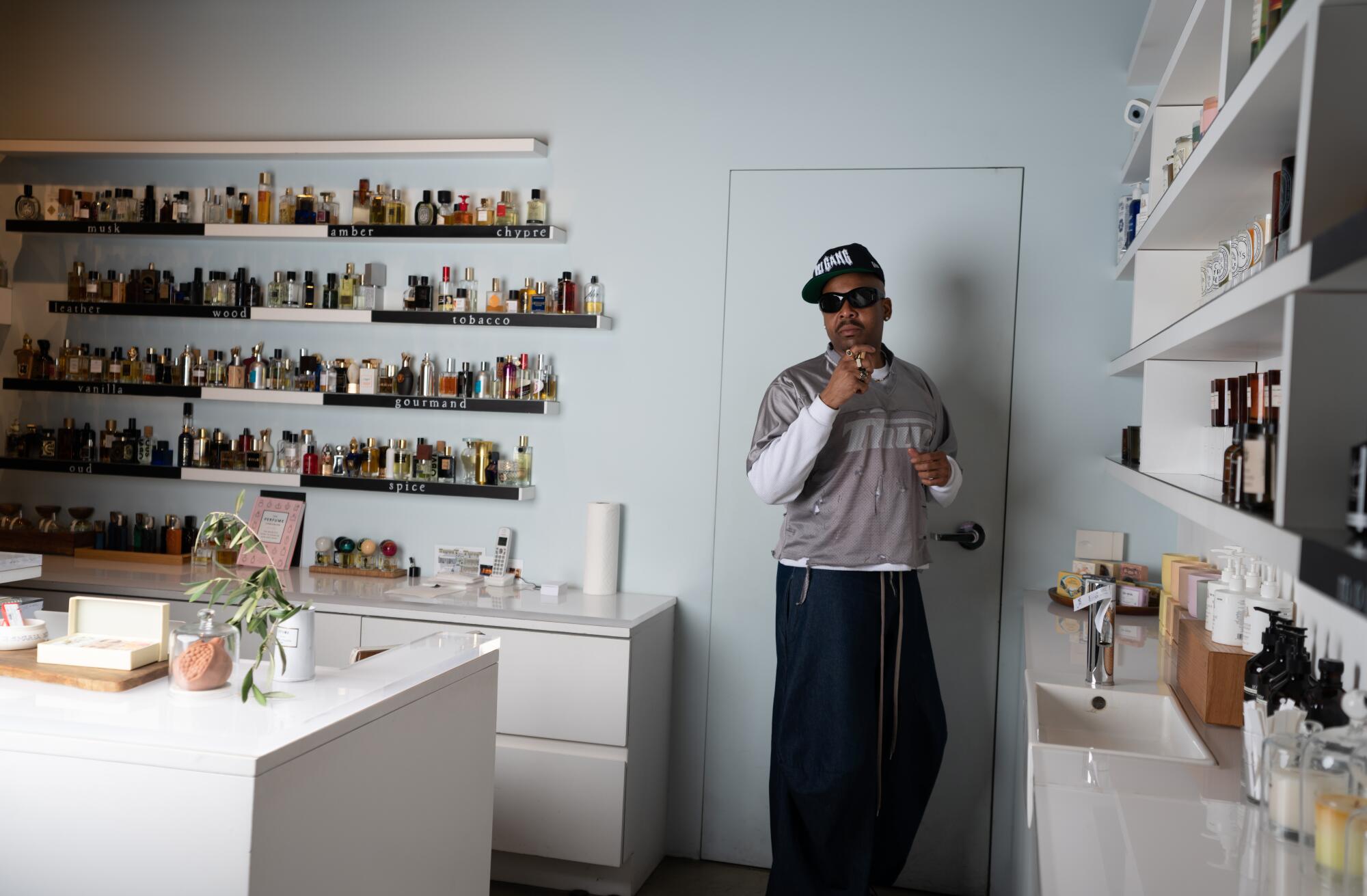 A man stands in a perfume shop.