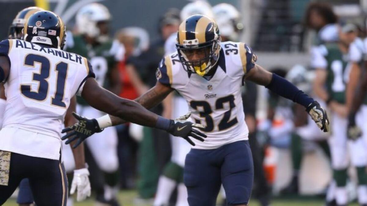 Cornerback Troy Hill (32) celebrates with safety Maurice Alexander after a play during a game against the Jets on Nov. 13.