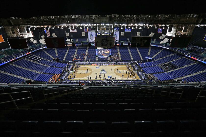 Greensboro Coliseum is mostly empty after the NCAA college basketball games were cancelled at the Atlantic Coast Conference tournament in Greensboro, N.C., Thursday, March 12, 2020. The biggest conferences in college sports all canceled their basketball tournaments because of the new coronavirus, seemingly putting the NCAA Tournament in doubt. (AP Photo/Gerry Broome)