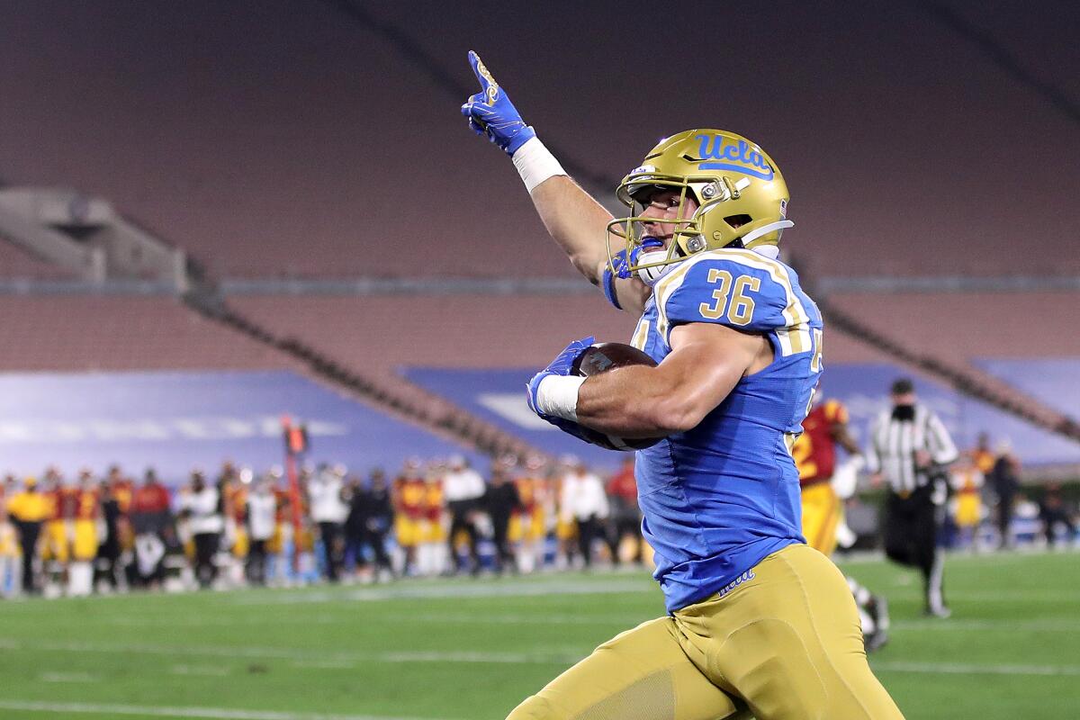 UCLA's Ethan Fernea reacts after scoring a rushing touchdown against USC 