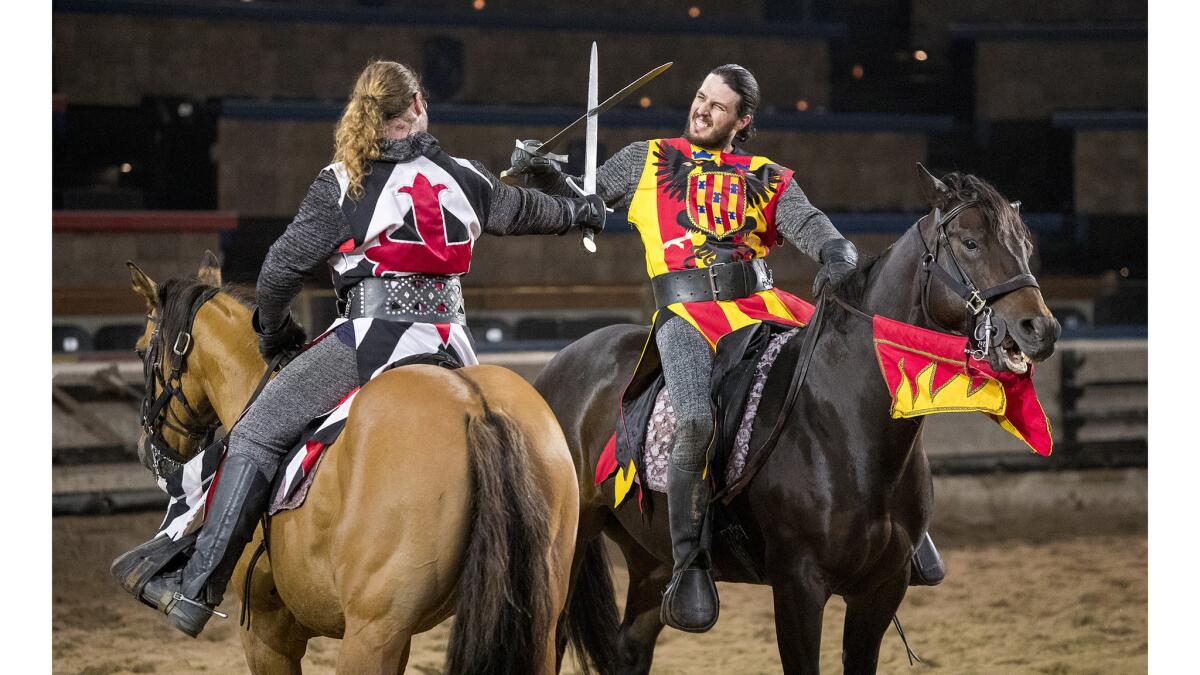 Phil La Croix, left, and Zack Synder rehearse a fight scene at Medieval Times in Buena Park on March 14.