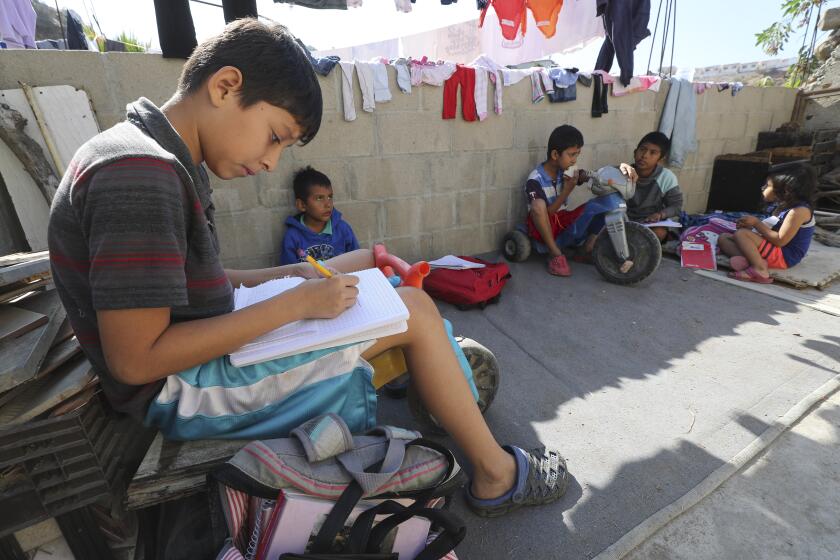 Carlos Jefferson, 12, from Honduras, works on math as he homeschools himself and other children at Su Casa, a home for Central American migrants, in Tijuana, Mexico on Thursday, November 14, 2019.
