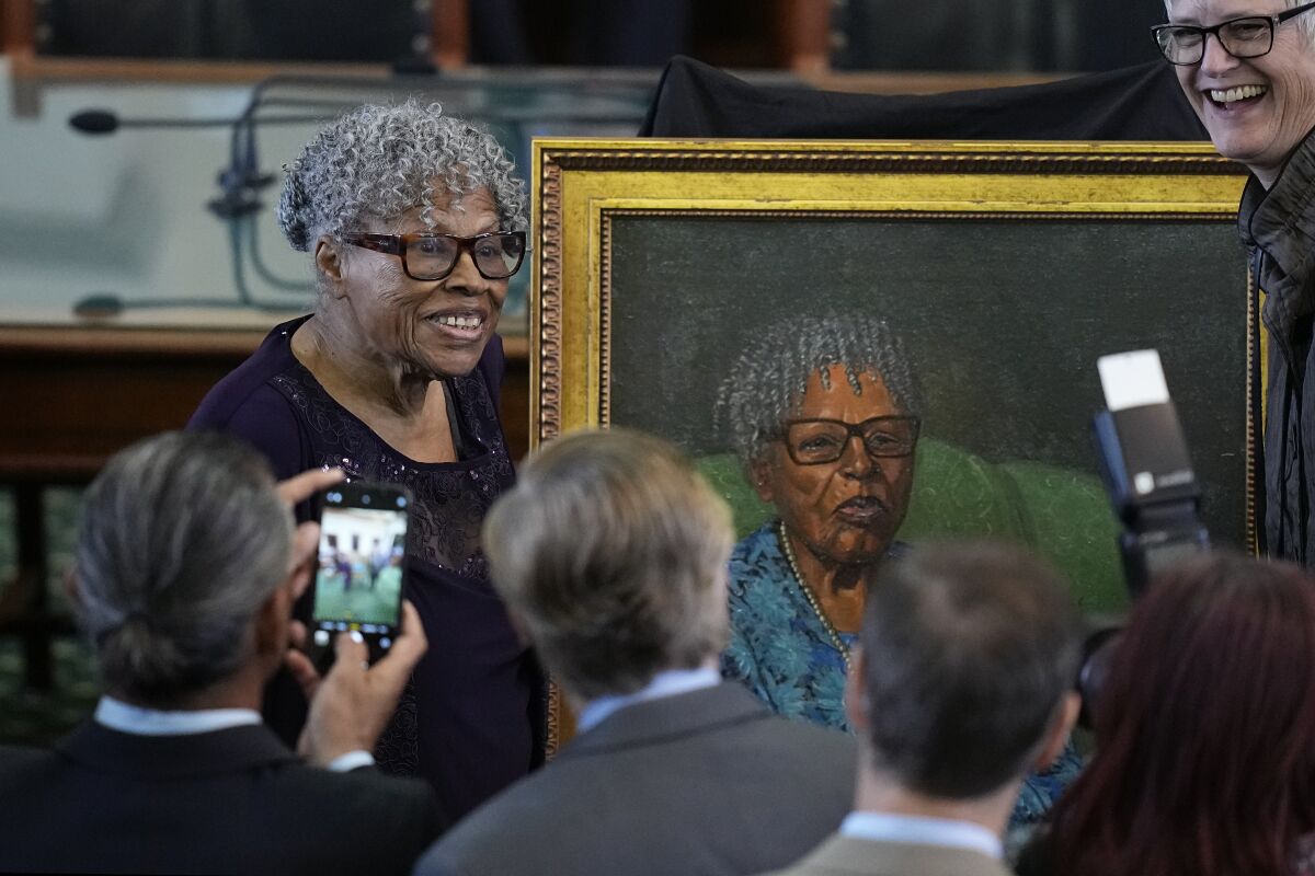 Opal Lee, left, who helped make Juneteenth a federally recognized holiday, poses with her portrait after it was unveiled in the Texas Senate Chamber, Wednesday, Feb. 8, 2023, in Austin, Texas. (AP Photo/Eric Gay)
