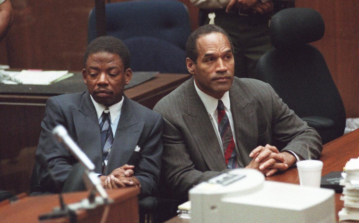 Attorney Carl Douglas, left, sits next to O.J. Simpson while the jury announces that it had reached a verdict on Oct. 2, 1995.