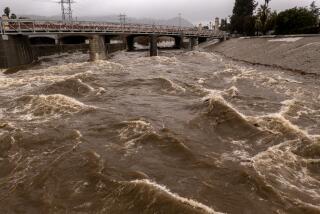 LOS ANGELES, CA - JANUARY 05: In an aerial view, the Los Angeles River flows at a powerful rate as a huge storm slams into the West Coast on January 5, 2023 in Los Angeles, California. California is being inundated by a "Pineapple Express" storm, or atmospheric river, and a bomb cyclone, a rapidly rotating storm system, bringing heavy rain and wind, and the threat of widespread flooding and possible landslides near wildfire burn areas. Coastal areas may sustain damage and heavy snow is accumulating the mountains. The dangerous storm condition has prompted California Gov. Gavin Newsom to declare a state of emergency. (Photo by David McNew/Getty Images)