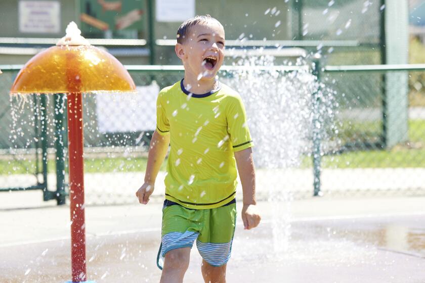 Hunter Sack, 7, runs through the water at Max Patterson park to escape from the heat during a record setting heat wave in Gladstone, Ore., Sunday, June 27, 2021. Yesterday set a record high for the day with more records expected today. (AP Photo/Craig Mitchelldyer)