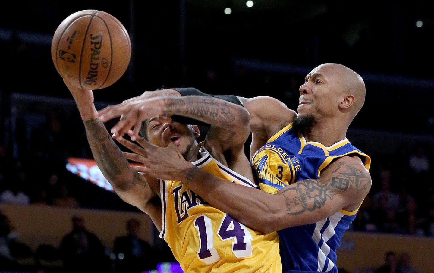 Lakers forward Brandon Ingram takes hard foul by Warriors forward David West in the first quarter.