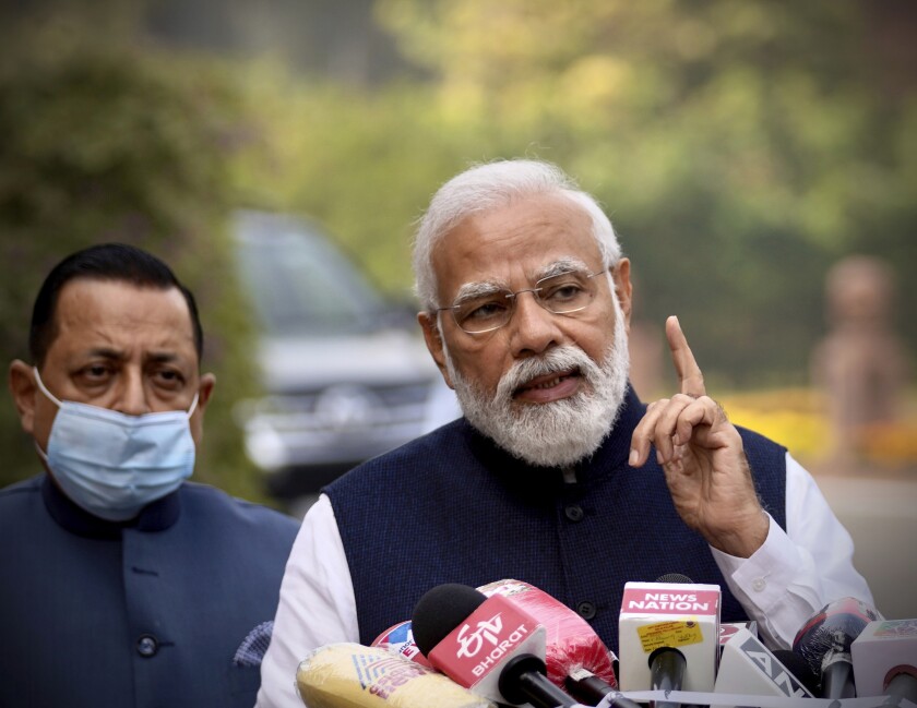 Indian Prime Minister Narendra Modi, addresses the media as he arrives to attend the opening day of the winter session of Parliament in New Delhi, India, Monday, Nov.29, 2021. India’s parliament on Monday repealed a set of controversial agriculture laws that inflamed tens of thousands of farmers, whose year-long protest has posed one of the biggest challenges to Modi’s administration. (AP Photo/Manish Swarup)