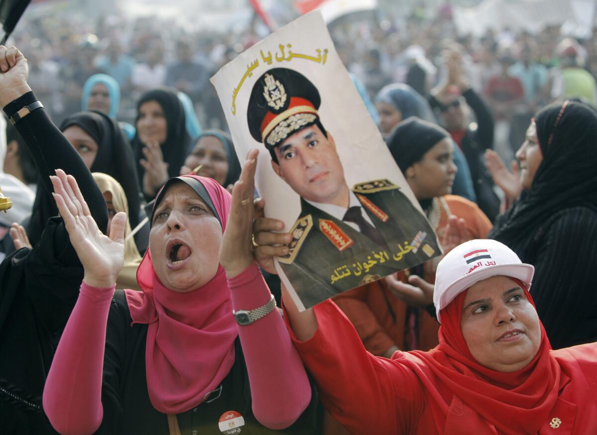 A woman holds a poster of Gen. Abdel Fattah Sisi, commander of Egypt's armed forces, during a demonstration Monday in Cairo's Tahrir Square.