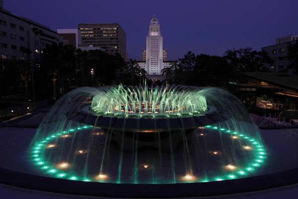 The Grand Park begins on the top of Bunker Hill along Grand Avenue with a dramatic view of a renovated Arthur J. Will Memorial Fountain and the tall white crest of Los Angeles City Hall. The fountain is programmed to run a colorful light show.