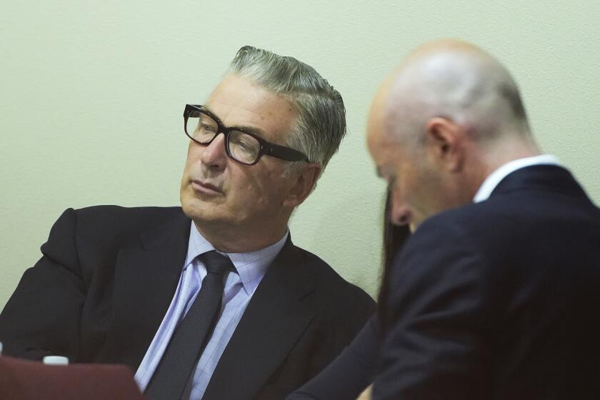 Actor Alec Baldwin, left, attends his trial for involuntary manslaughter for the 2021 fatal shooting of cinematographer Halyna Hutchins during filming of the Western movie "Rust," Friday, July 12, 2024, at Santa Fe County District Court in Santa Fe, N.M. (Ramsay de Give/Pool Photo via AP)