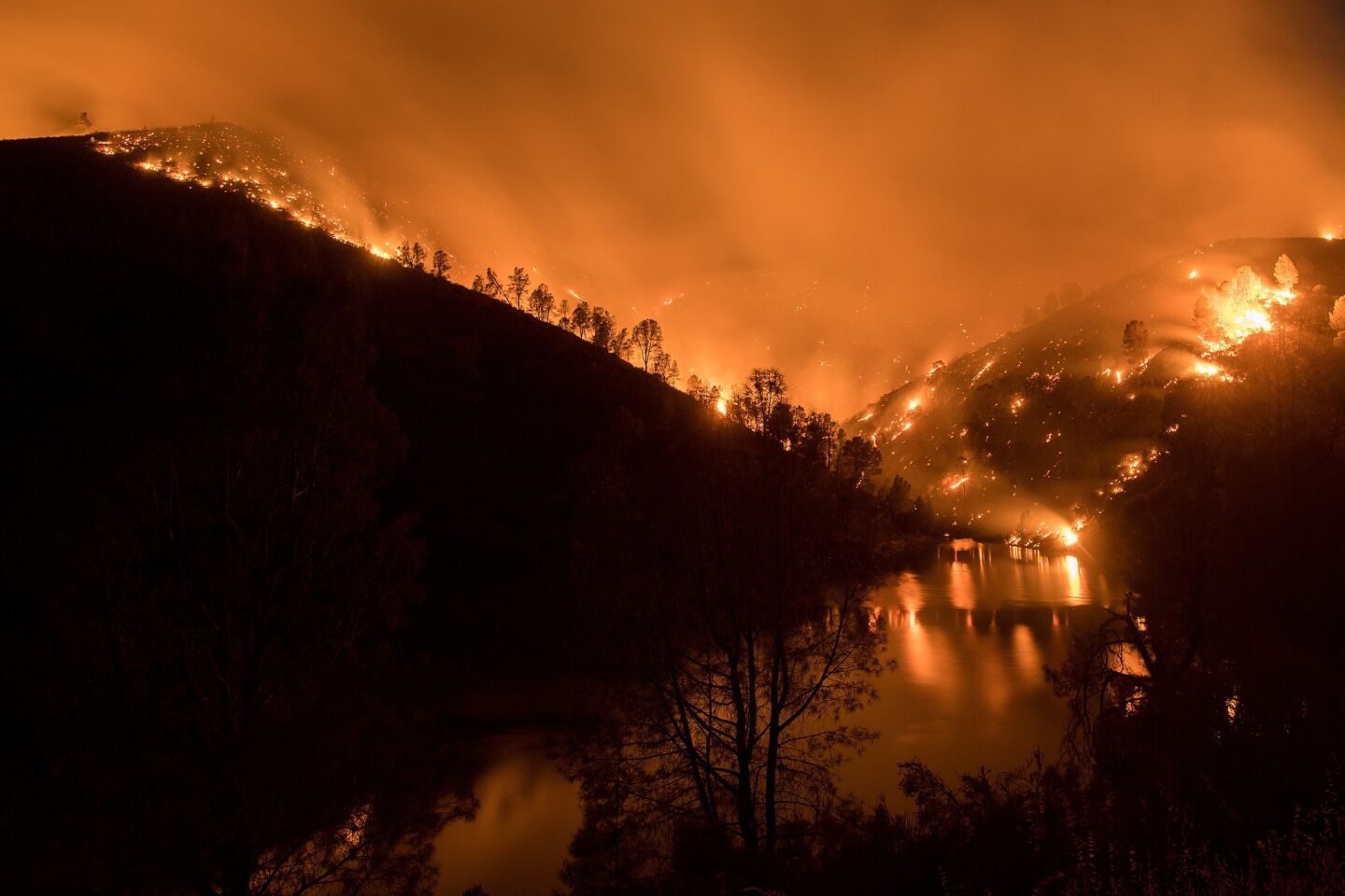 The Detwiller Fire burns above Lake McClure near Bear Valley.