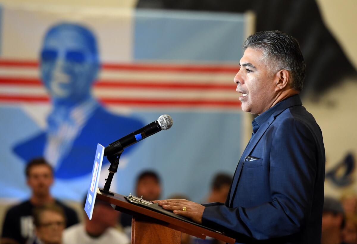 Congressman Tony Cárdenas speaks into a microphone at a lectern