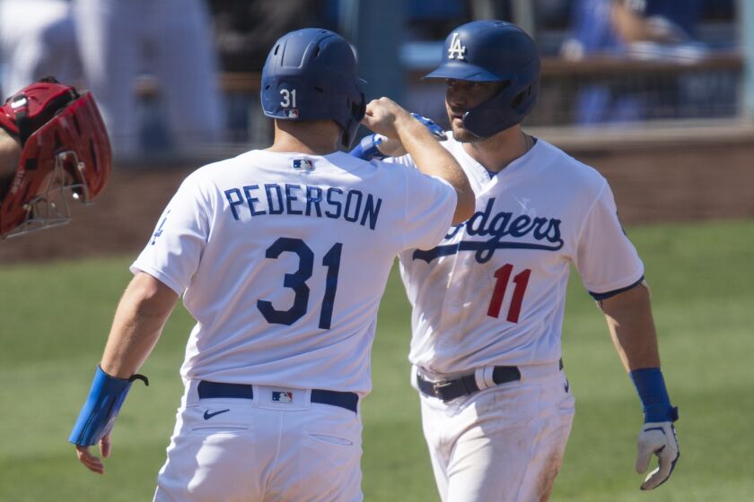 Los Angeles Dodgers' A.J. Pollock, right, celebrates his two-run home run with Joc Pederson, center.