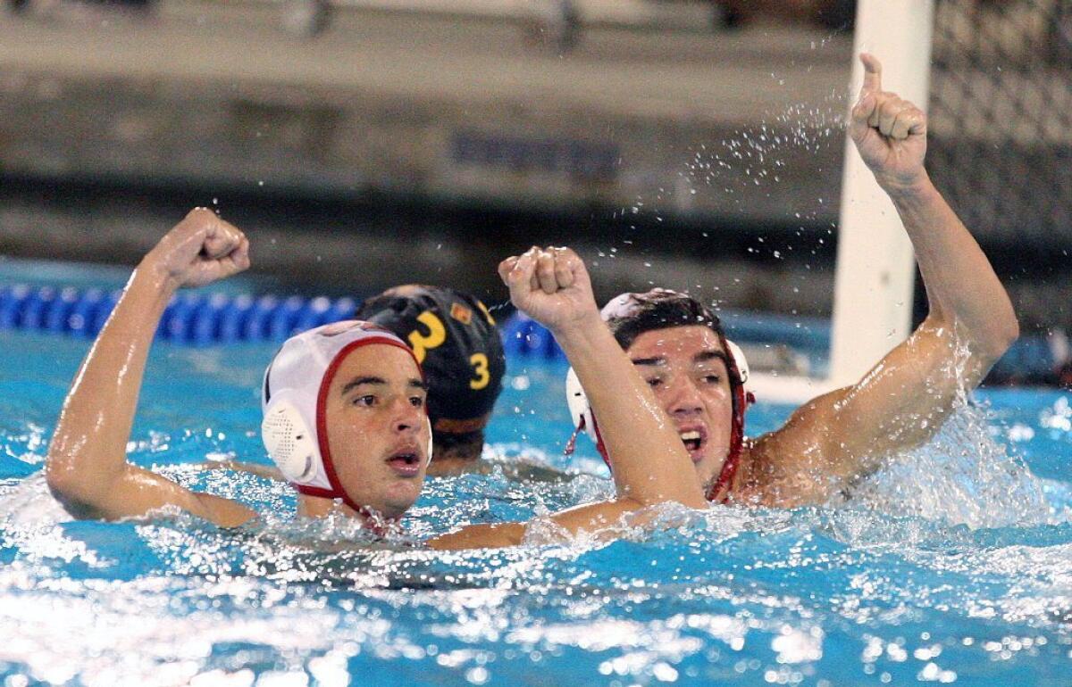 Burroughs High's David Arakelyan and LJ Burns celebrate during their 9-7 win over La Cañada in the CIF Southern Section Division V semifinals on Wednesday.