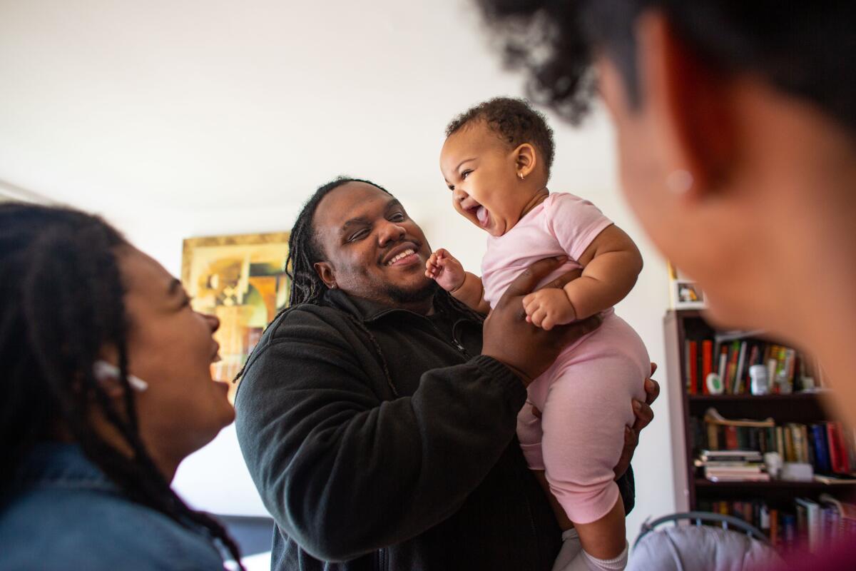 Henry Ephriam with Gloria Mapp-Parker and their baby daughter